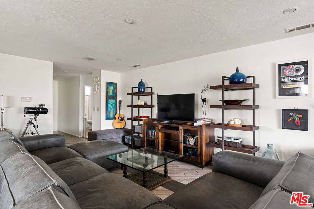 12960 Greensboro Road Victorville, CA 92395 - Photo 16 of 34 a living room with furniture and a flat screen tv