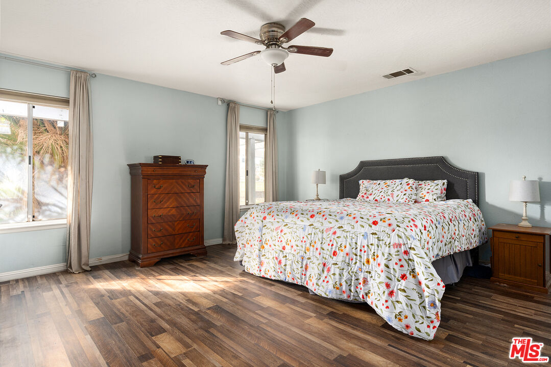 12960 Greensboro Road Victorville, CA 92395 - Photo 18 of 34 a bedroom with a bed and a window