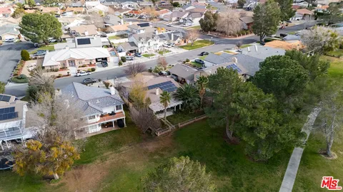 an aerial view of residential building and trees around