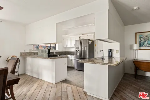 a kitchen with appliances a sink and cabinets