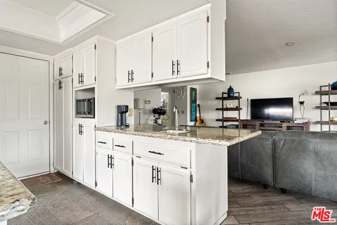 a kitchen with stainless steel appliances granite countertop a sink and cabinets