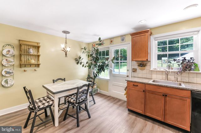 a view of a dining room with furniture and window