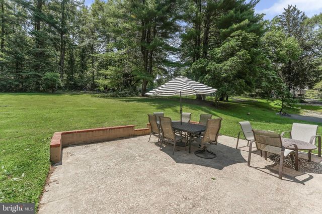 an outdoor sitting area with furniture and umbrella