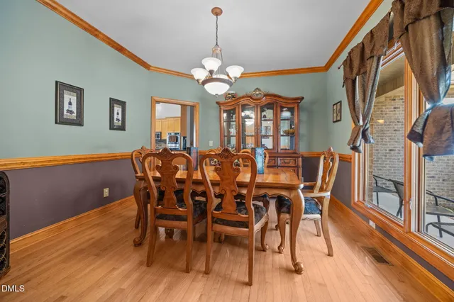 a view of a dining room with furniture wooden floor and chandelier