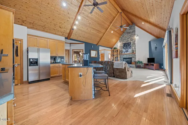 a living room with stainless steel appliances kitchen island granite countertop furniture and a kitchen view