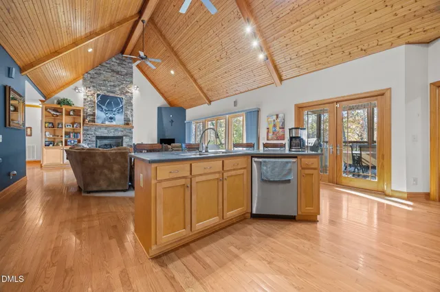 a kitchen with stainless steel appliances granite countertop a stove a sink dishwasher and a microwave oven with cabinets