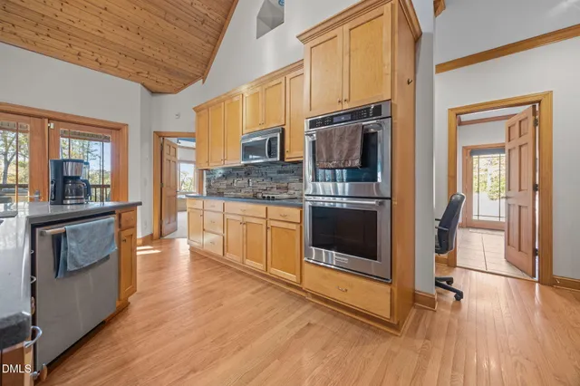 a kitchen with stainless steel appliances a stove a sink and a refrigerator