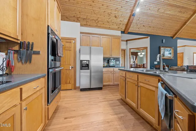 a kitchen with stainless steel appliances granite countertop a refrigerator and a sink