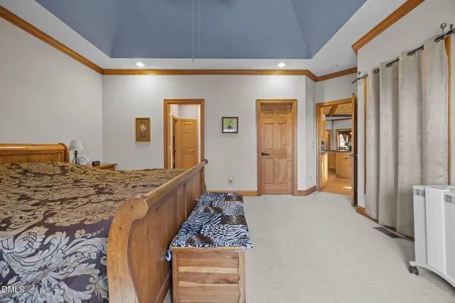 a bedroom with a large bed and walk in closet