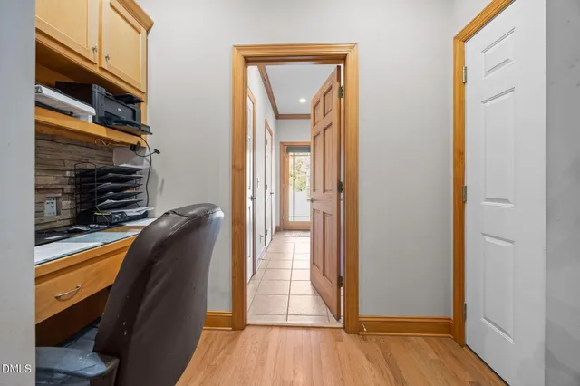 a view of a hallway with wooden floor and glass door