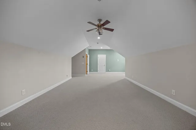 a view of a livingroom with a ceiling fan and window