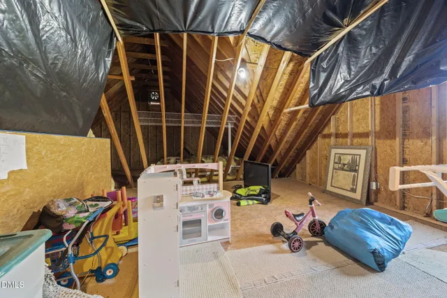 a view of empty room with wooden ceiling