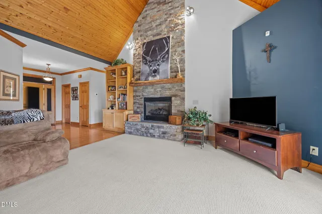 a spacious bedroom with a large bed and a chandelier