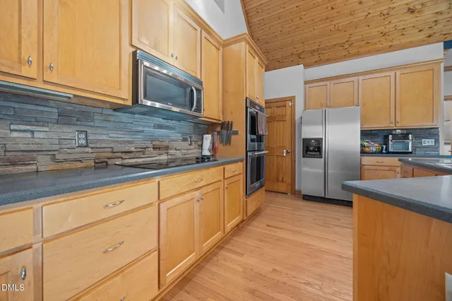a view of a balcony with furniture and wooden floor