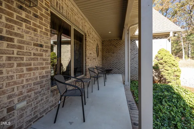 a view of a patio with table and chairs and potted plants
