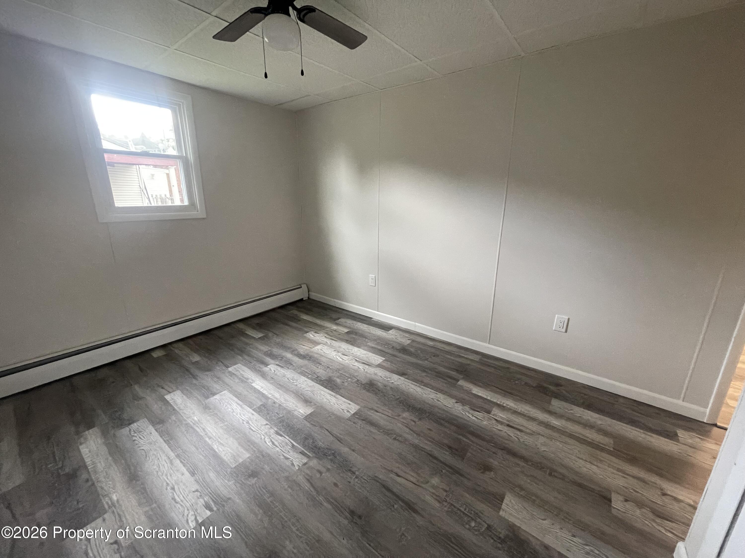 238 George Street Moosic, PA 18507 - Photo 15 of 23 a view of an empty room with a window and wooden floor