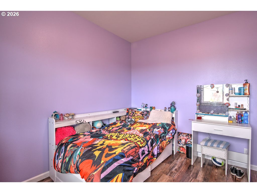 1966 34th Street Florence, OR 97439 - Photo 14 of 17 a bed room with a bed and a desk