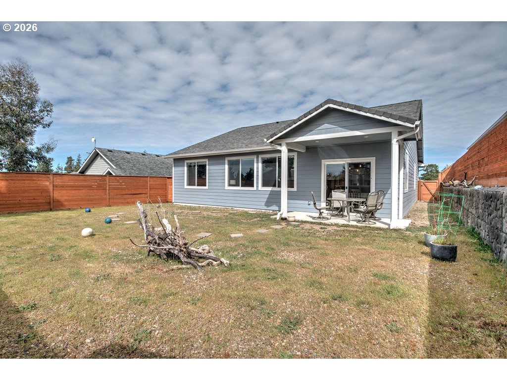 1966 34th Street Florence, OR 97439 - Photo 16 of 17 a view of a house with a backyard