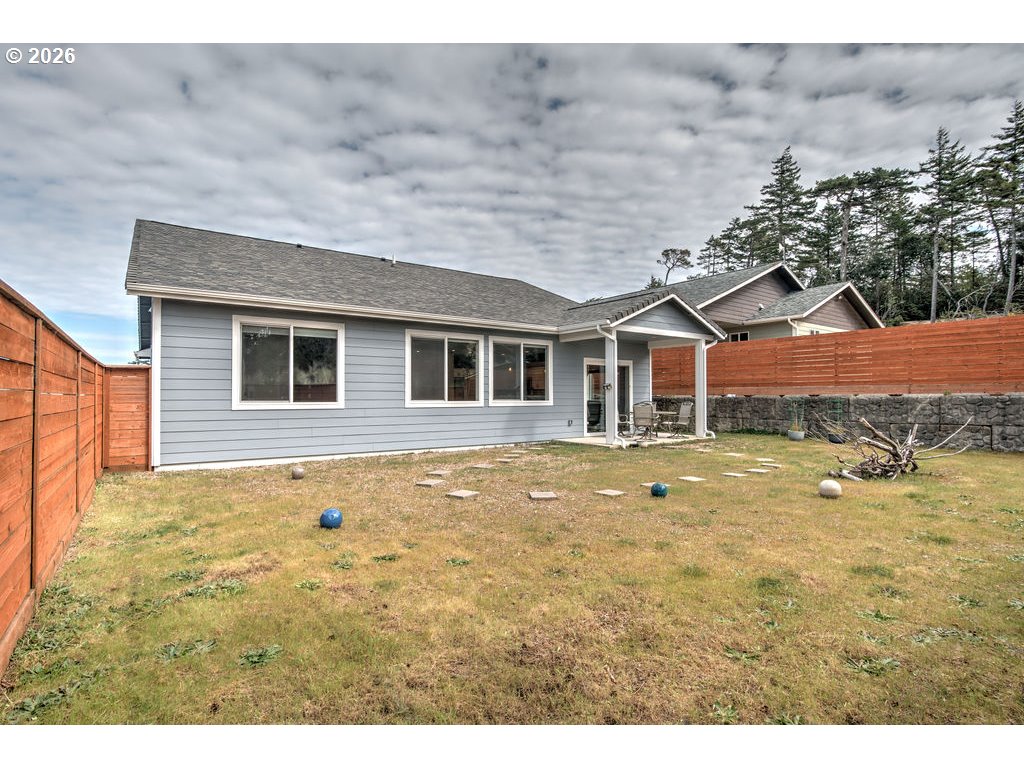 1966 34th Street Florence, OR 97439 - Photo 17 of 17 a view of a house with a backyard