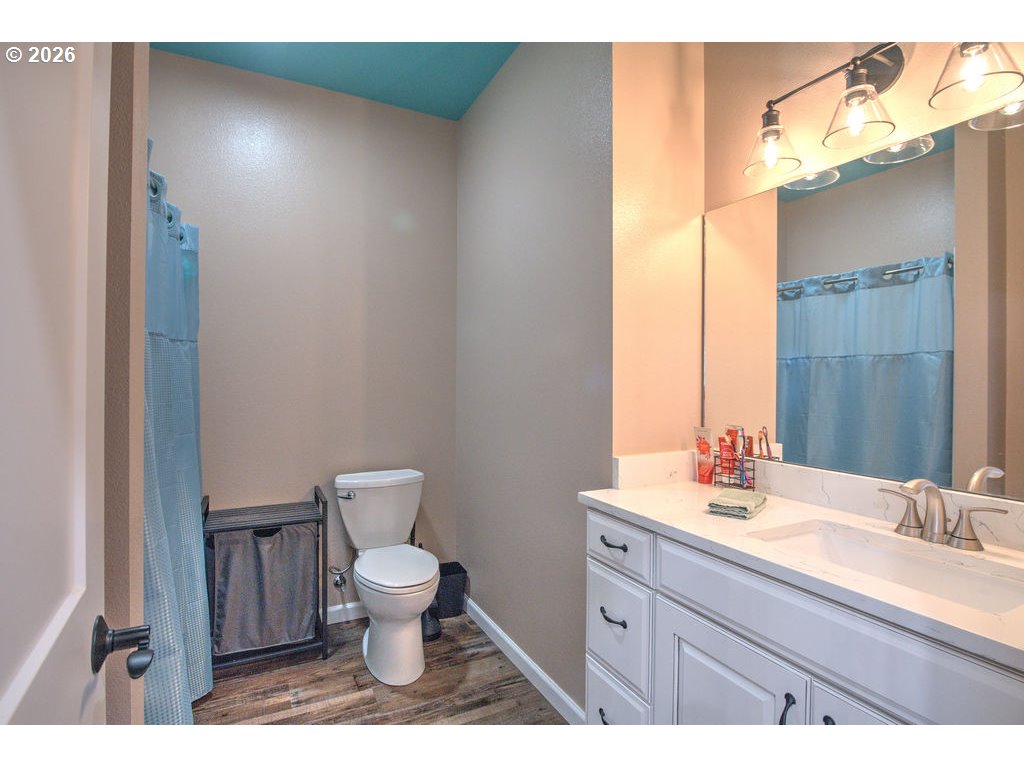 1966 34th Street Florence, OR 97439 - Photo 8 of 17 a bathroom with a toilet a sink and mirror