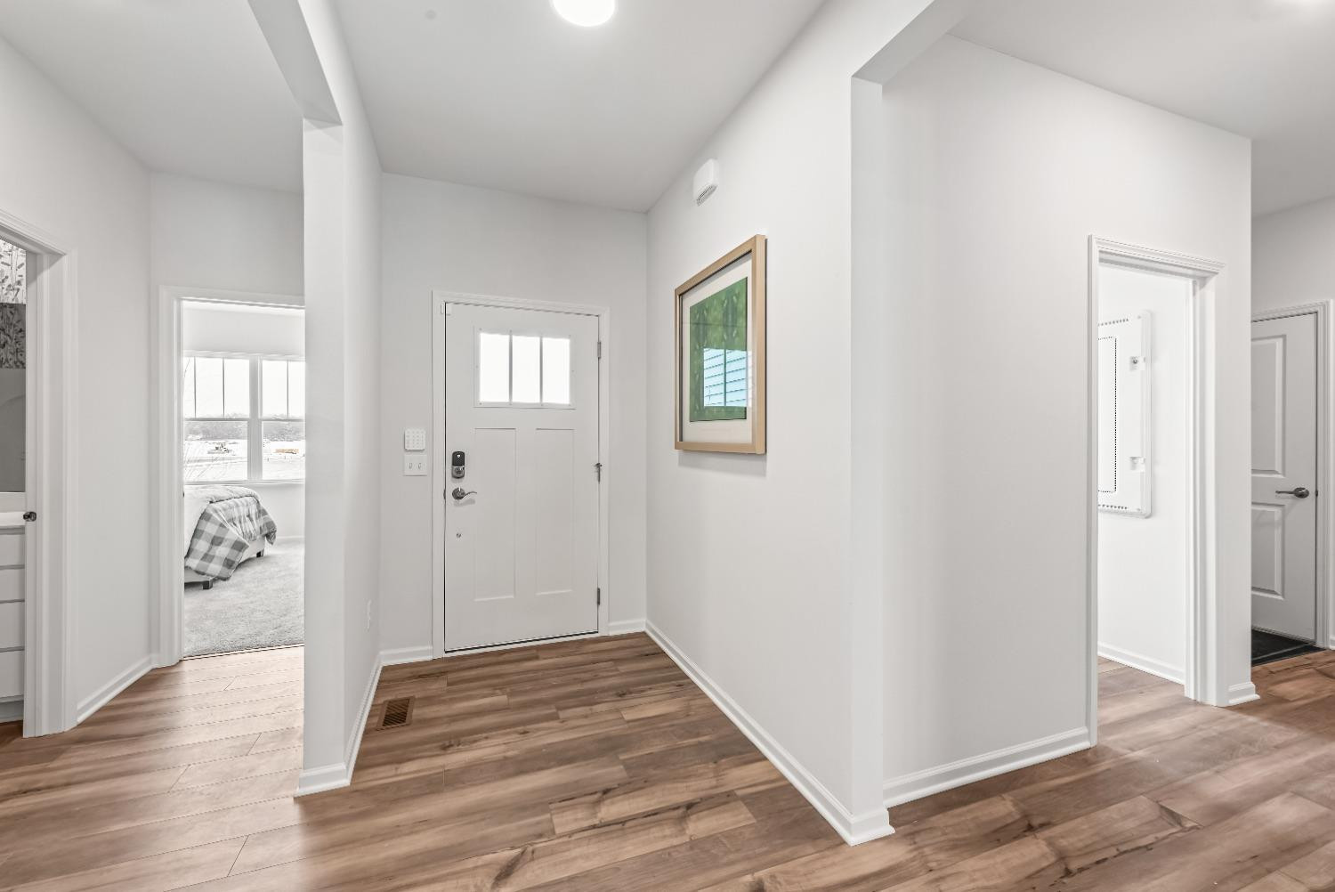 8553 Graystone Drive Lowell, IN 46356 - Photo 2 of 27 an empty room with wooden floor and windows