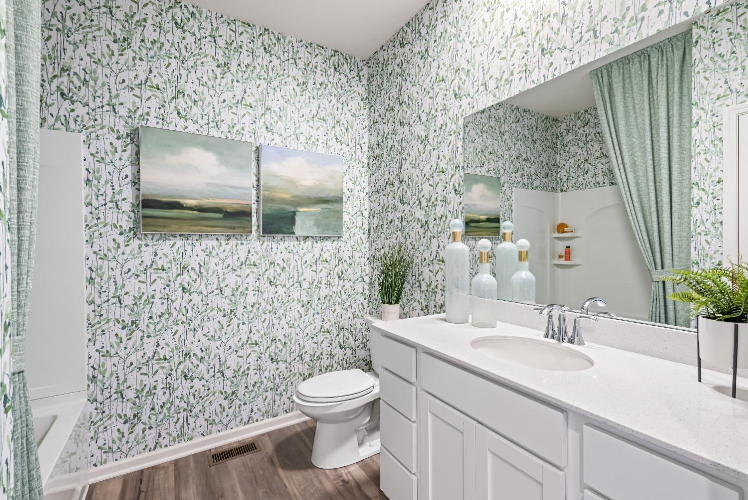 8553 Graystone Drive Lowell, IN 46356 - Photo 21 of 27 a bathroom with a granite countertop sink a toilet and mirror