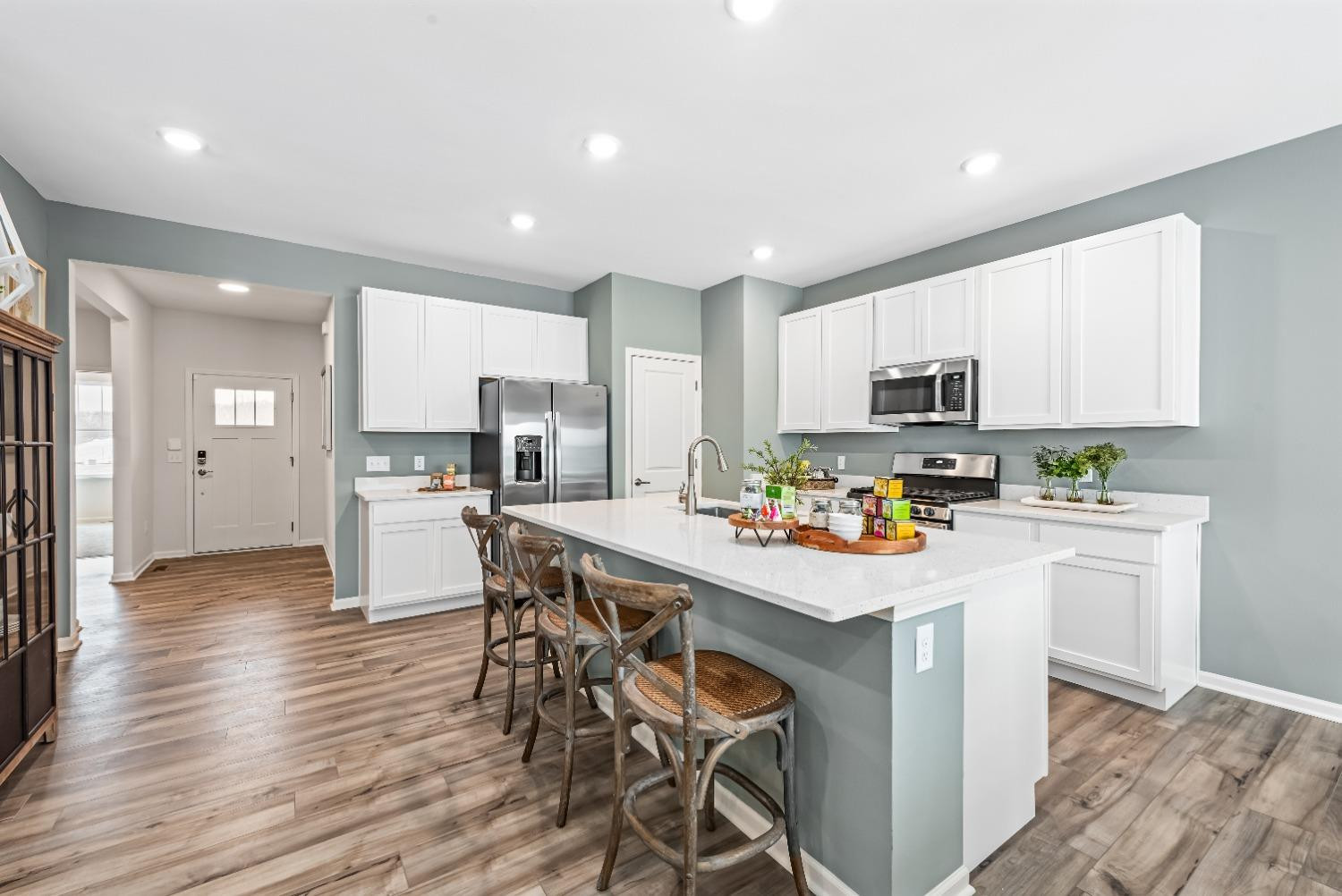 8553 Graystone Drive Lowell, IN 46356 - Photo 8 of 27 a kitchen with kitchen island wooden cabinets and refrigerator