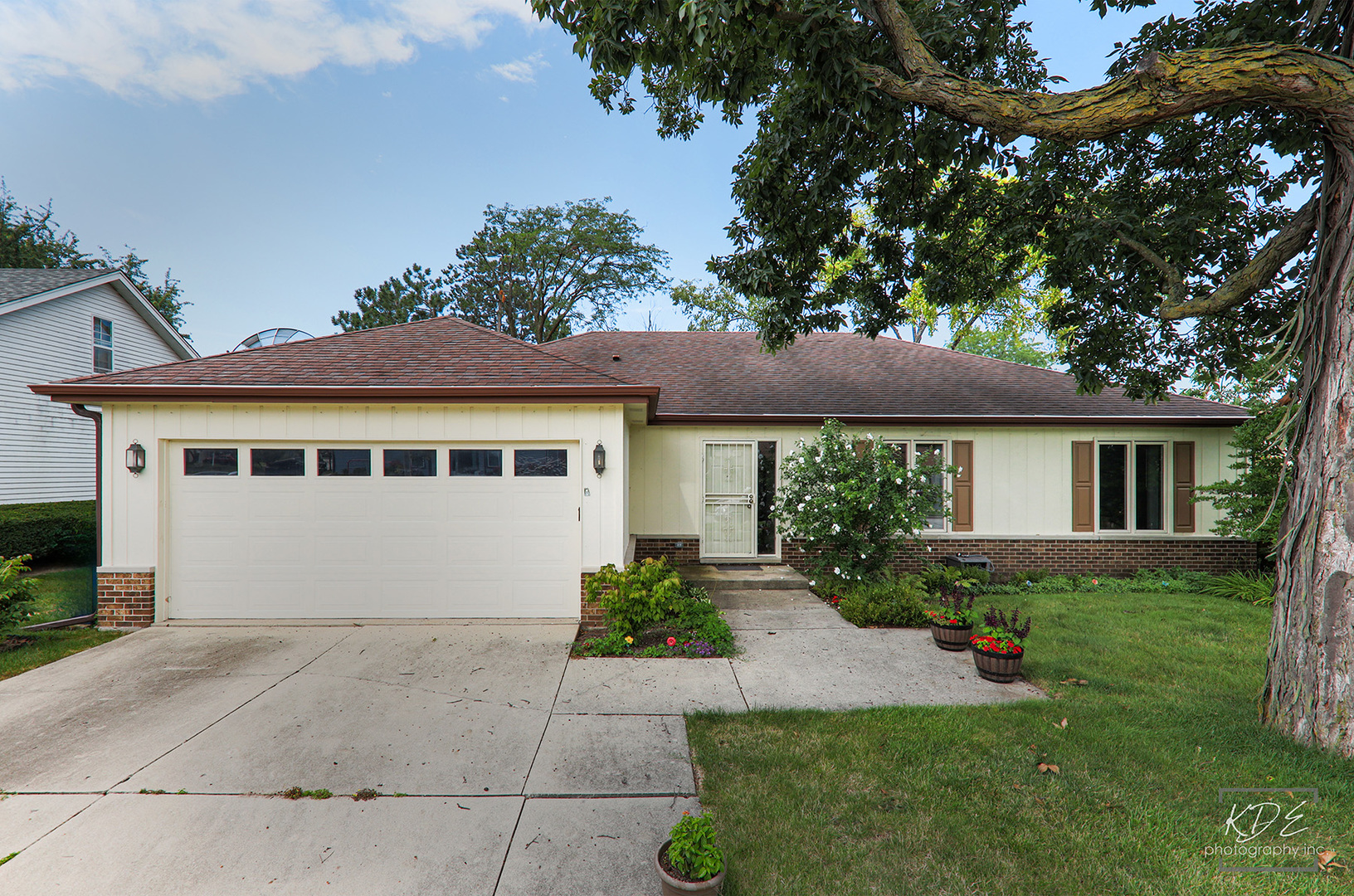 1505 Ranchview Drive Naperville, IL 60565 - Photo 35 of 36 a front view of a house with a yard and potted plants