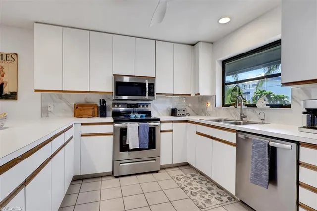 a bedroom with bed and a chandelier