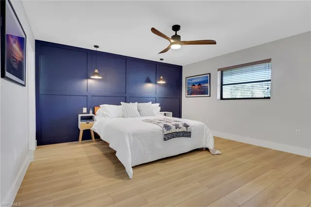 a bedroom with a large bed and a chandelier