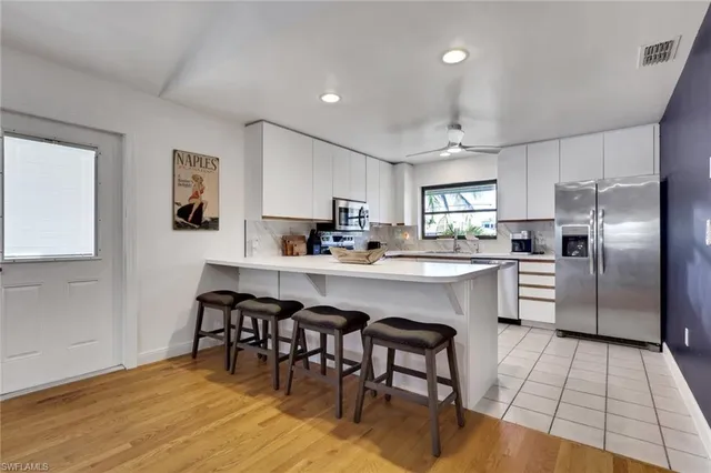a kitchen with cabinets a window and appliances