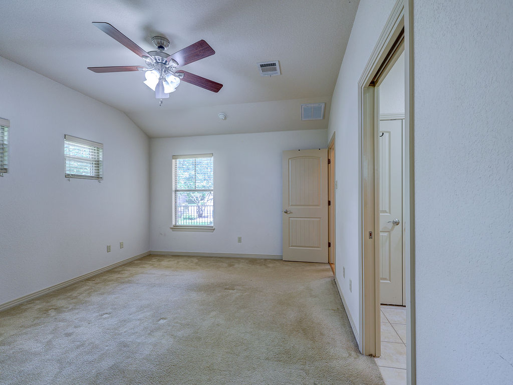 9707 Anderson Mill Road, Unit 22 Austin, TX 78750 - Photo 32 of 39 An airy bedroom with vaulted ceilings offers a quiet retreat.