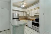 9731 West McNab Road, Unit 208 Tamarac, FL 33321 - Photo 8 of 13 a kitchen with stainless steel appliances granite countertop a refrigerator a stove and a sink