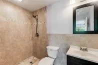 a bathroom with a sink toilet and shower