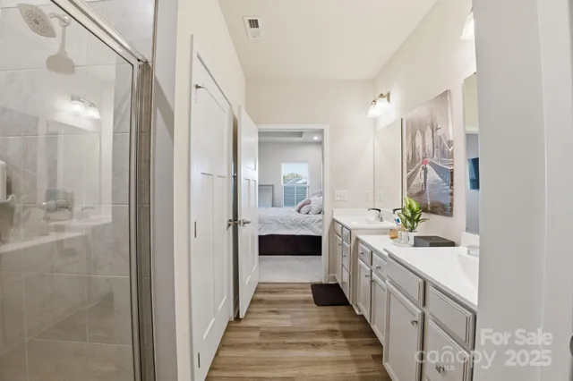 a bathroom with a double vanity sink and a mirror