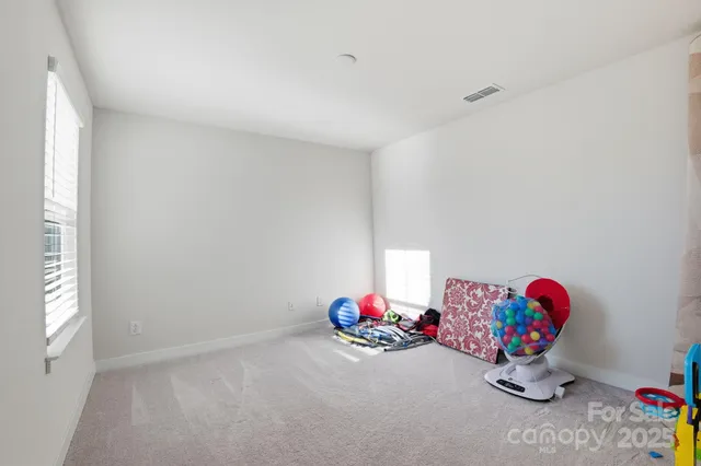 a bedroom with furniture and a flat screen tv