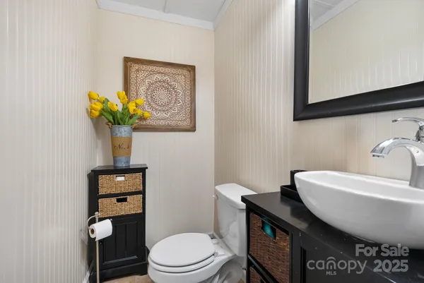 a bathroom with a toilet a sink and mirror