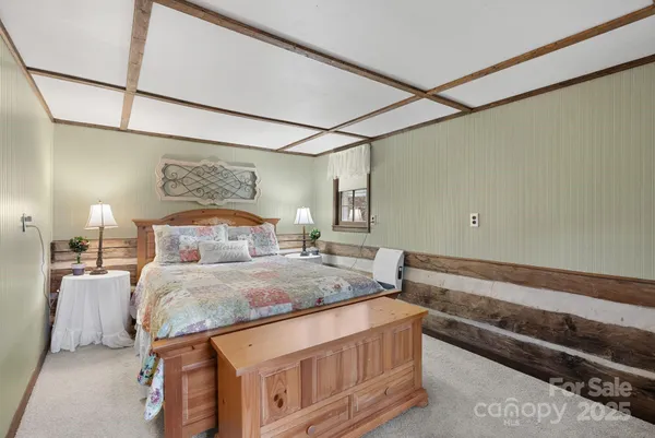 a bedroom with a bed and a night stand