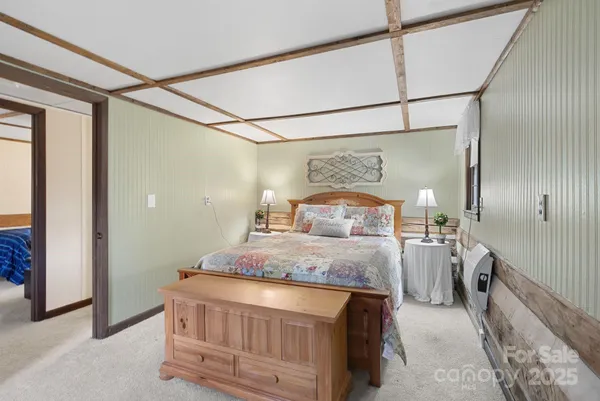 a bedroom with a bed and a mirror