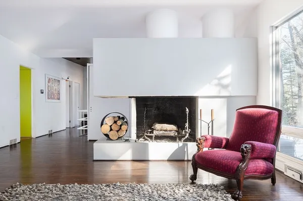 a living room with furniture rug and wooden floor