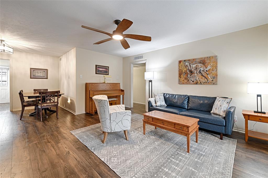 10757 Villager Road, Unit D Dallas, TX 75230 - Photo 1 of 21 a living room with furniture and a wooden floor