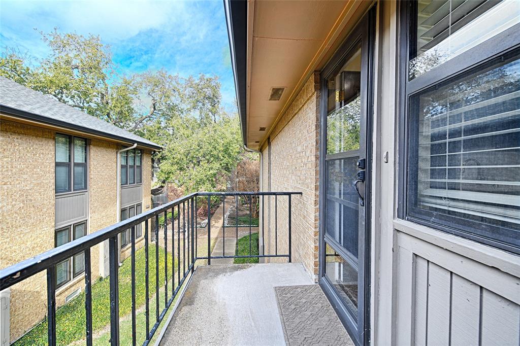 10757 Villager Road, Unit D Dallas, TX 75230 - Photo 11 of 21 a view of a balcony and trees