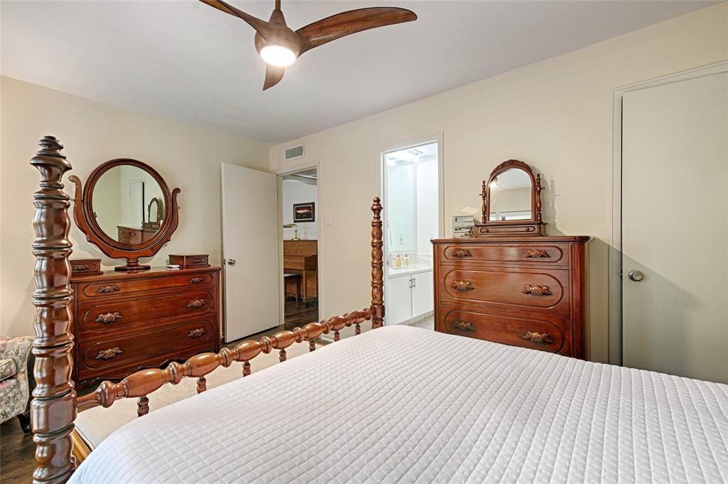 10757 Villager Road, Unit D Dallas, TX 75230 - Photo 13 of 21 a bedroom with a bed and a dresser