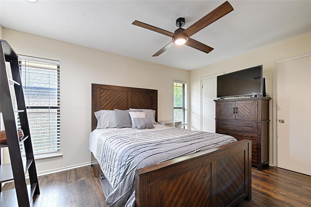 10757 Villager Road, Unit D Dallas, TX 75230 - Photo 16 of 21 a bedroom with a bed and a flat screen tv