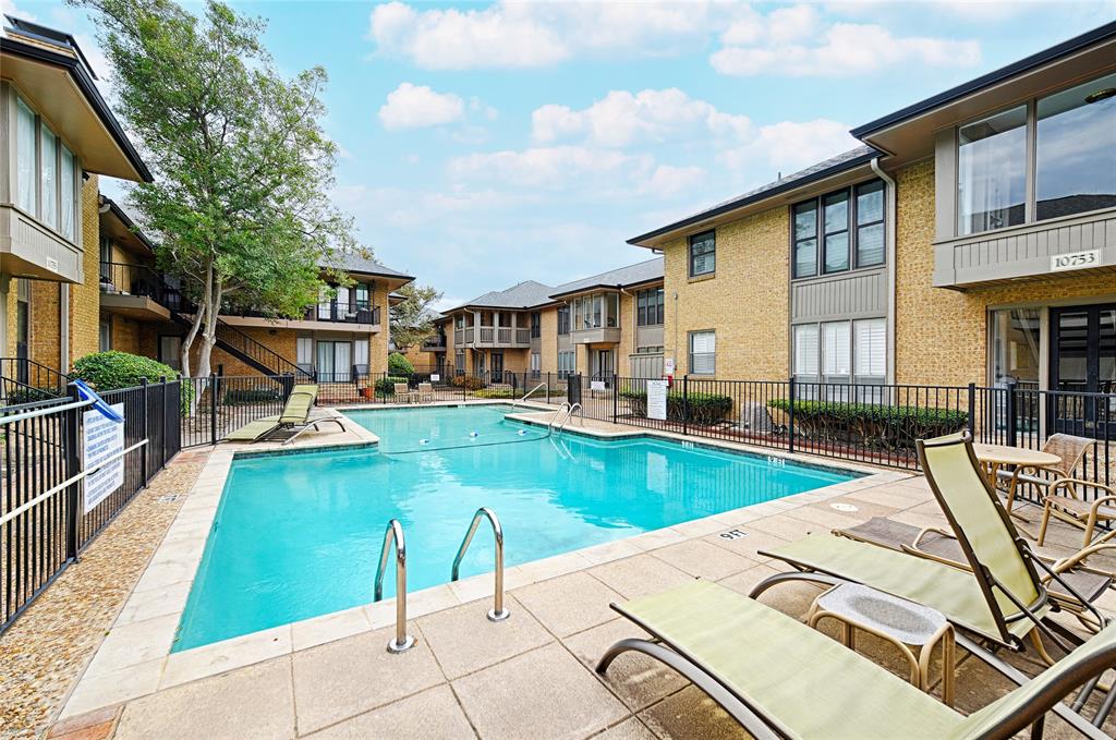 10757 Villager Road, Unit D Dallas, TX 75230 - Photo 20 of 21 a view of a house with swimming pool and sitting area