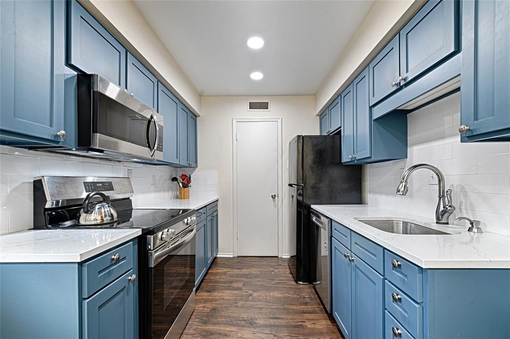 10757 Villager Road, Unit D Dallas, TX 75230 - Photo 2 of 21 a kitchen with stainless steel appliances granite countertop a sink stove and refrigerator