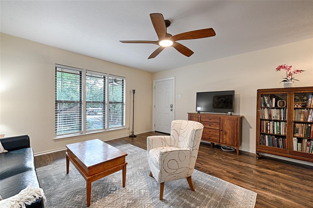 10757 Villager Road, Unit D Dallas, TX 75230 - Photo 6 of 21 a living room with furniture a flat screen tv and a window