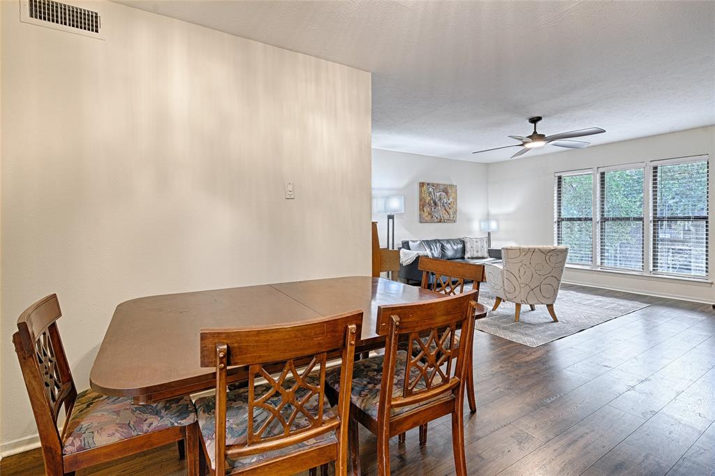 10757 Villager Road, Unit D Dallas, TX 75230 - Photo 8 of 21 a dining room with furniture and wooden floor