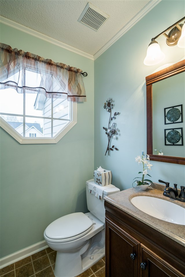 5213 Denmead Way Raleigh, NC 27613 - Photo 15 of 25 a bathroom with a granite countertop toilet sink and mirror
