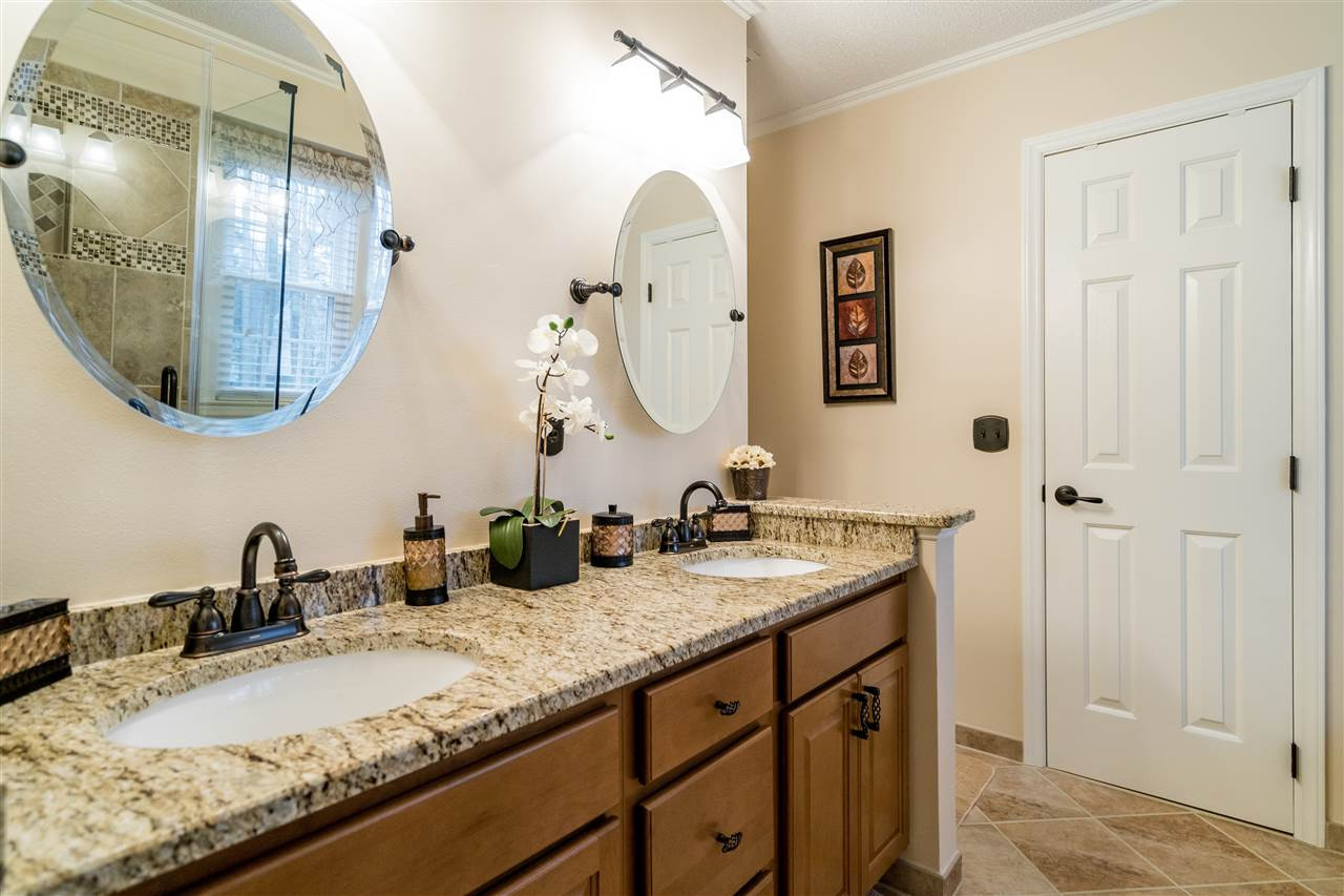 5213 Denmead Way Raleigh, NC 27613 - Photo 18 of 25 a bathroom with a granite countertop sink and a mirror